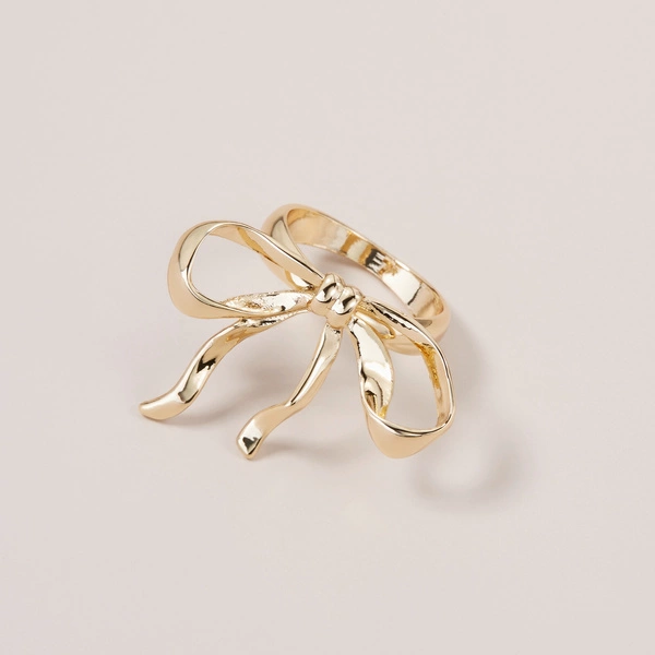 Złoty pierścionek ze stali z ozdobną dużą kokardą. CATCH LA